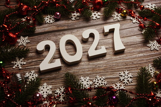 2027 Happy New Year and Christmas decoration on wooden background