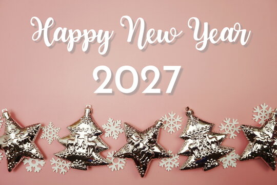 Happy New Year 2027 text with Christmas element decoration on pink background