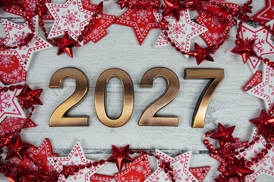 Happy New Year 2027 alphabet letters with Christmas decoration on pink background