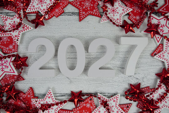 Happy New Year 2027 alphabet letters with Christmas decoration on pink background