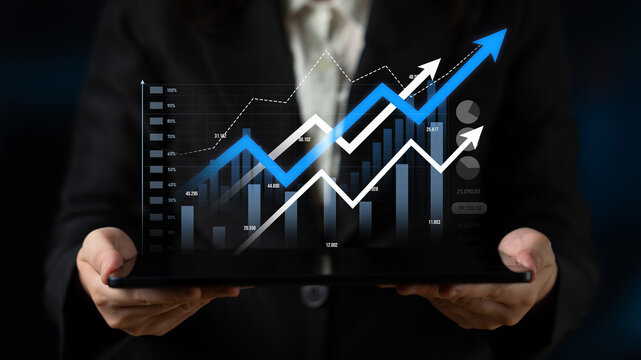 A business professional presents a tablet featuring a financial growth chart with various upward trending graphs and data analytics, symbolizing success and progress. Scalp