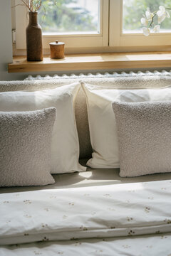 White bedding, pillows and cushions on bed