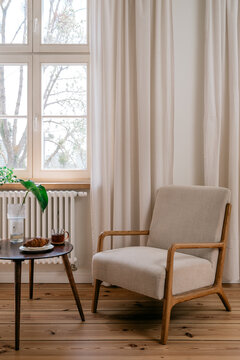 Cozy living room interior with vintage armchair and wooden floor