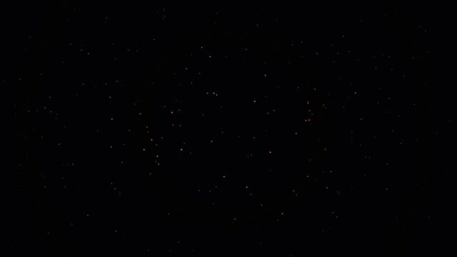 Thousands of tiny glowing points and fire embers floating upward slowly with a deep bokeh effect over a dark black background. Minimalist, cinematic, and dramatic aesthetic.