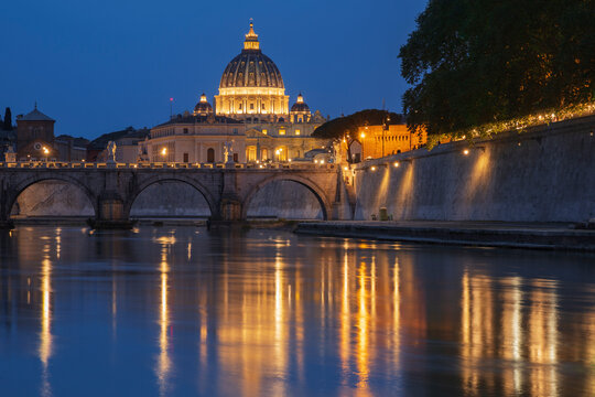 View of st peter's basilica and Tiber River at dusk in rome