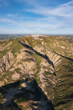 Hill town of Pisticci with rugged calanche hills in basilicata, Italy
