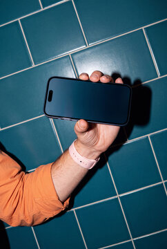 Horizontal Phone Against Teal Tiles