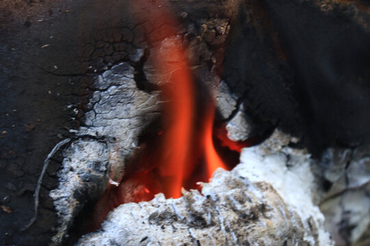 Glowing ember in charcoal