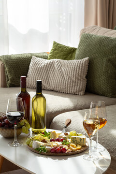 Sophisticated wine and cheese platter arranged elegantly on a table with bottles and glasses