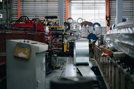 Professional industry engineer focused on metal sheet production in factory atmosphere feeling busy with work for development and growth