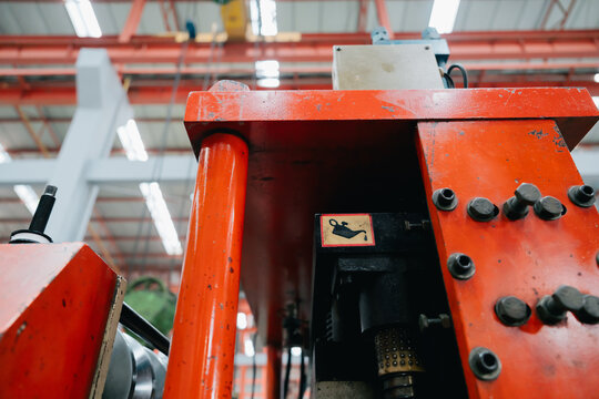 Industrial metal sheet factory engineer working with machinery and feeling productive in busy workshop setting for manufacturing production