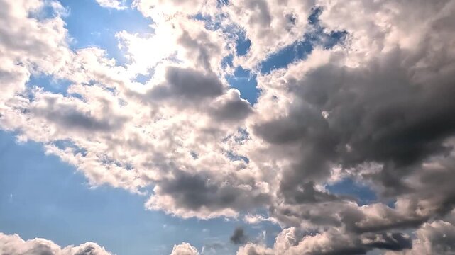 Fast flowing of dramatic clouds in the Daylight Skies. 4K video (Ultra High Definition) of cloudscape and bright sun. Sky and clouds Timelapse. 