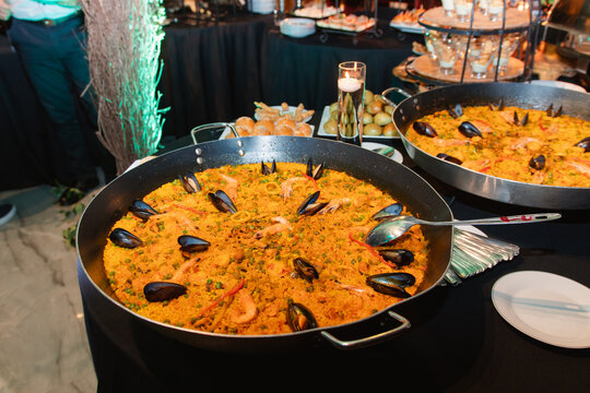 A large paella pan&mdash;paella being a traditional Spanish dish based on yellow rice with mussels and seafood.