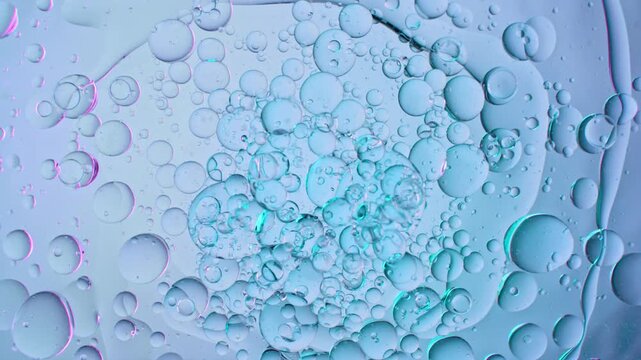 Super Slow Motion Shot of Rotating Oil in Water at 1000fps. Abstract Cosmetic Background.