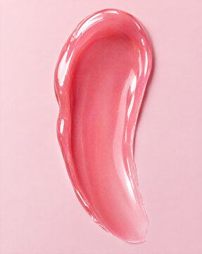 Glossy balm smear texture in pink cosmetic swatch style  
