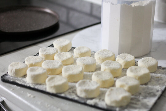 Homemade syrnyky being prepared on a bright kitchen counter