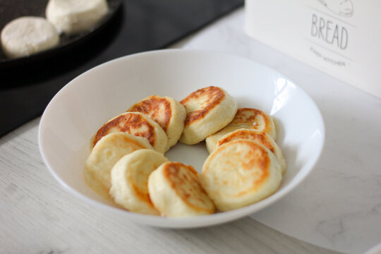 Homemade syrnyky freshly fried in a pan for a traditional breakfast