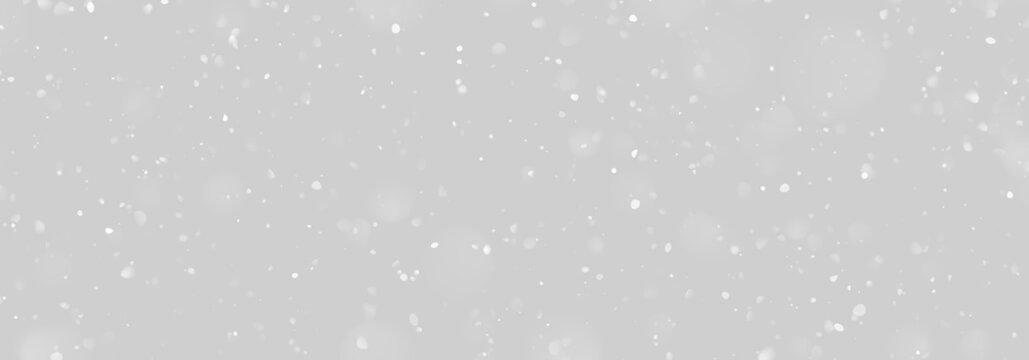 Soft white particles floating against a black background create a scattered effect. The varying sizes and opacity add depth and subtle movement. This composition works well for winter or.