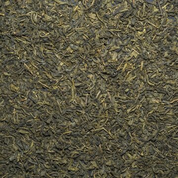 Close-up view of dried green tea leaves texture background