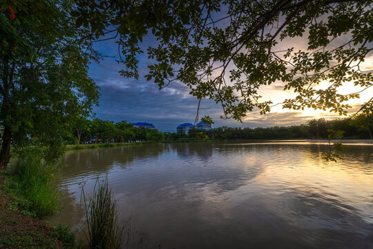 road landscape lake views and the reservoir the forest summer with evening blue dramatic sunset sky nature background.