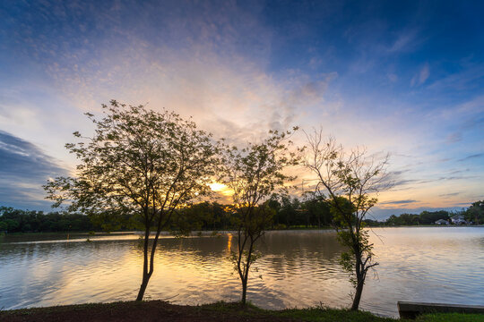 road landscape lake views and the reservoir the forest summer with evening blue dramatic sunset sky nature background.