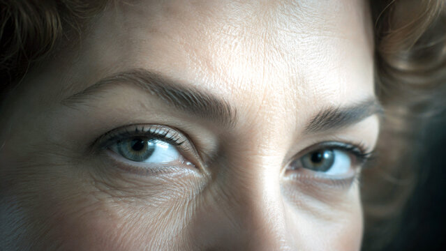 Close up of a mature woman's eyes showing natural skin texture, fine lines and wrinkles around the eye area