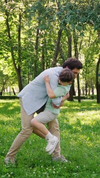 Joyful and loving father happily catches energetic little son