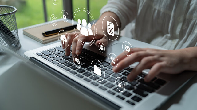 A person typing on a laptop with various digital icons floating, symbolizing communication and data management. This scene captures modern work dynamics and digital interactions. Nascent