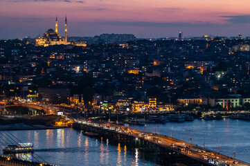 Fototapeta premium Istanbul skyline at night, lit bridges over water, mosques shine