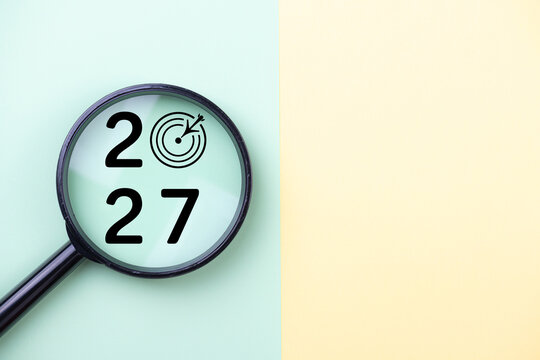 2027 New Year card. New Years goals 2027 with magnifying glass, target icon. Concept 2027 New Year background. Business, resolutions, goals, inspiration, financial, success, ideas