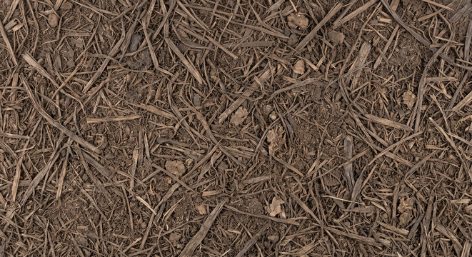 Dried digestate fiber after anaerobic digestion shown as a full-frame field of dry interwoven fibrous residue with brittle fragments and natural earthy texture