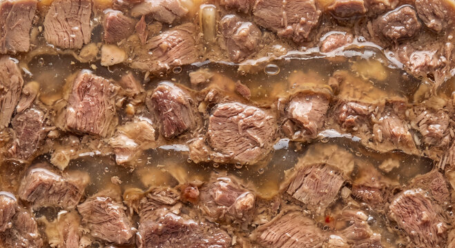Close up of meat chunks preserved in jelly or gravy