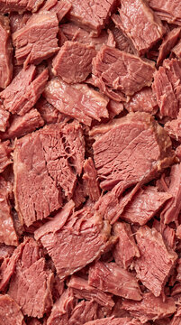 Canned corned beef chunks and flakes packed closely together in detailed close view