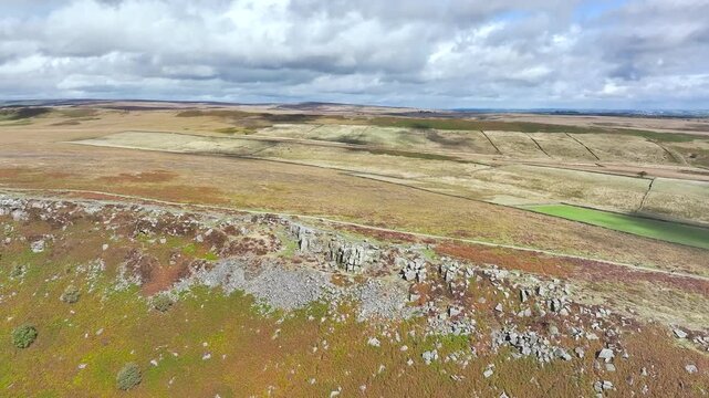 Rocks and Moorland over Curbar Edge and Hope Valley from a drone, Peak District National Park, Curbar, Calver, England, UK