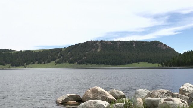 Mountains with rocks in front of lake scene

