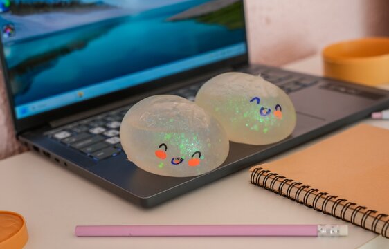 Two cute kawaii dumpling squish antistress toys with pencil on desk
