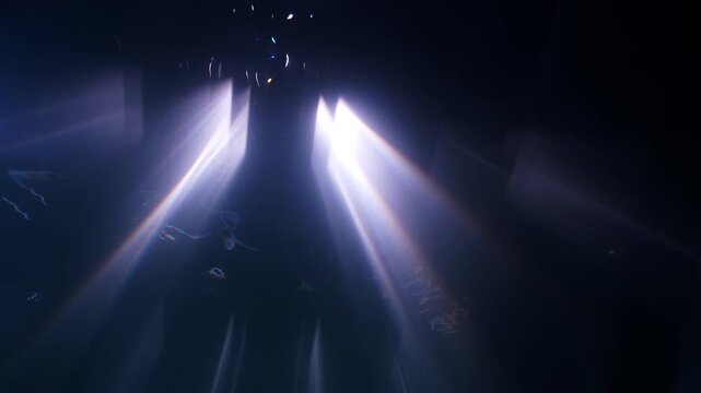 Abstract underwater shot of light filtering down from pier deck
