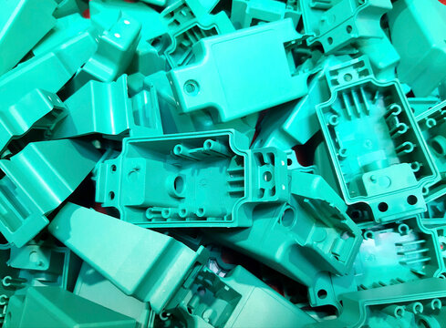 Horizontal background of industrial plastic parts texture. Pattern of manufactured polymer components, mass production and technical design concept.