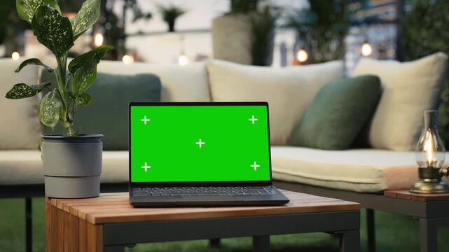 Close up of green screen laptop in rooftop workspace