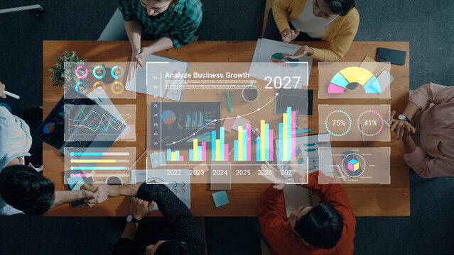A business team engages in a collaborative meeting focused on data analysis, examining colorful graphs and charts to inform future growth strategies and decisions. Cyphers