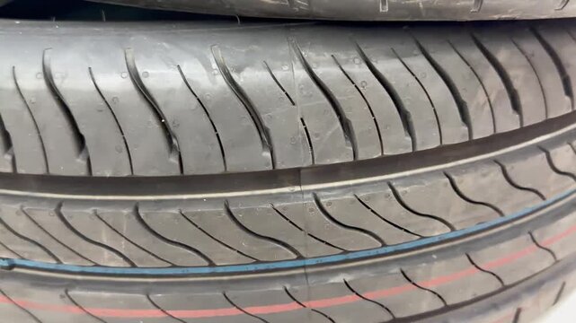 Detailed close-up of tire tread pattern with distinct rubber grooves, showcasing automotive texture, ideal for transport, vehicle, and safety performance concepts.