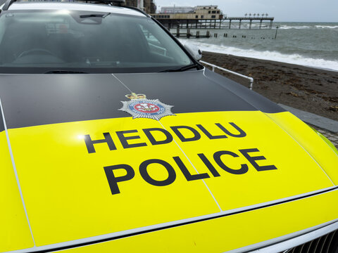 Aberystwyth, Wales, UK - September 4, 2026; Dyfed Powys Police car with name in closeup high visibility colors