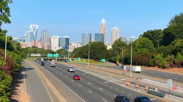 Moving cars along a highway with the Charlotte skyline and copy space