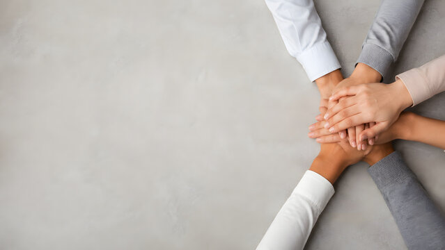 Stacked teamwork hands banner with broad copy space