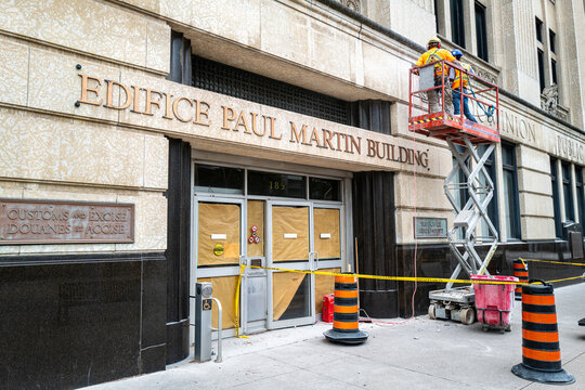 Workers renovate the entrance of the historic Edifice Paul Martin Building in Windsor, illustrating heritage restoration and urban downtown redevelopment projects. July 2026