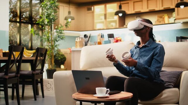 Young woman uses VR glasses for immersive 3D visualization and motion tracking, combining futuristic multitasking with virtual reality at home.