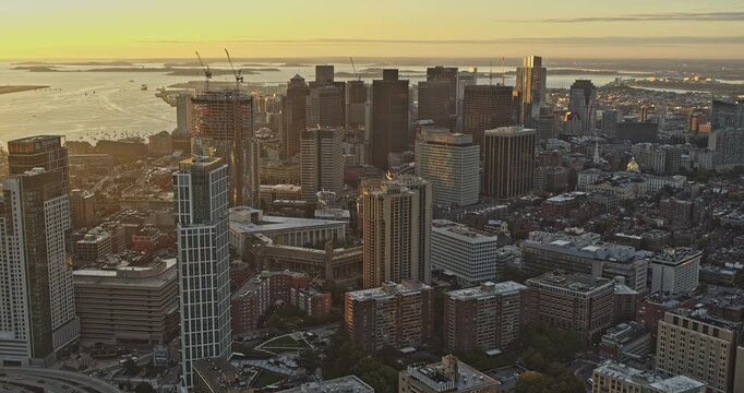 Boston Massachusetts Aerial v241 high angle birds eye view of sunrise cityscape across airport, west end, downtown and beacon hill neighborhoods - Shot with Inspire 2, X7 camera - October 2021