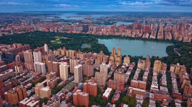 Scenic view on the huge Central Park in the modern cityscape. Sunset panorama of modern New York City, USA at sunset.