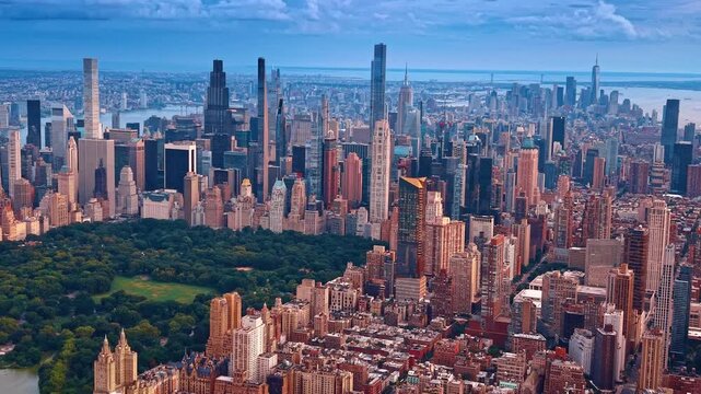 Stunning architecture around the lush greenery of Central Park. Sunset view of modern New York City, USA from drone.