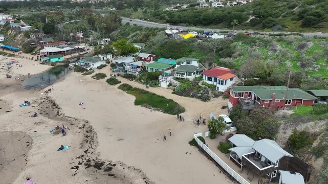 Crystal Cove, California, USA - Aerial View of Laguna Beach State Park Along Pacific Coast Highway With Historic Beach Cottages, Tourists, Crashing Waves and Rugged Shoreline on a Cloudy Day